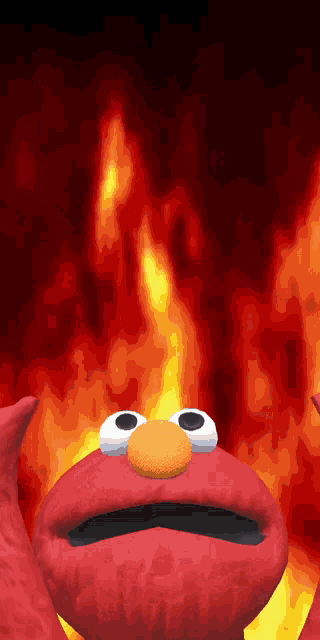 elmo from sesame street standing in front of a fire