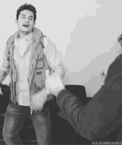 a black and white photo of two men dancing with the caption mr. john mayer