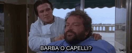 a man with a beard is getting his hair cut by a barber and says barba o capelli