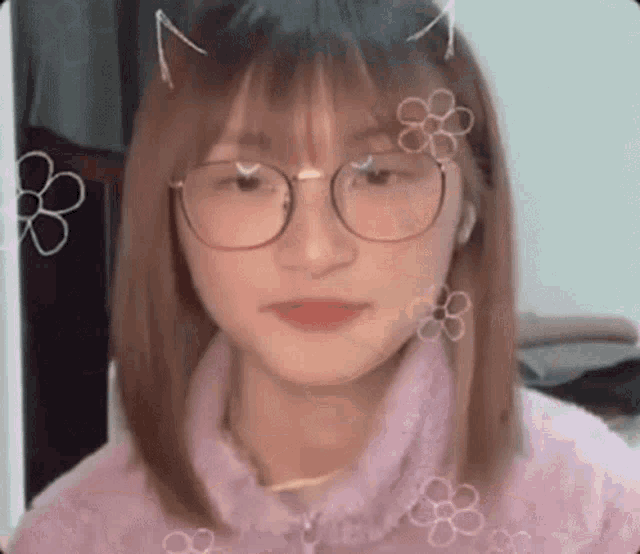 a girl wearing glasses and a purple sweater is looking at the camera .