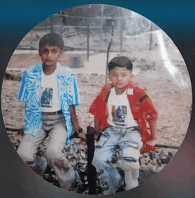 two young boys are sitting next to each other in a circle and one has the number 66 on his shirt