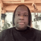 a close up of a man 's face with a nose ring on it .