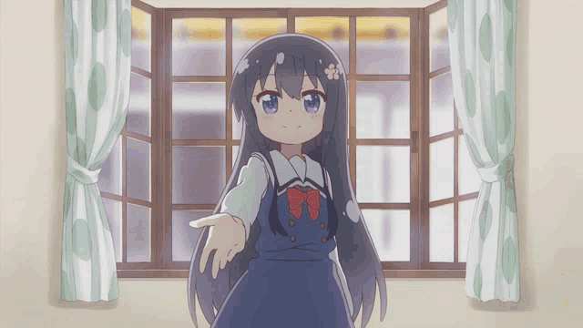 a girl with long hair is standing in front of a window with polka dot curtains