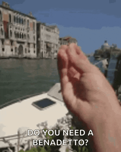 a person 's hand is reaching out towards a boat in the water and says `` do you need a benadetto ''