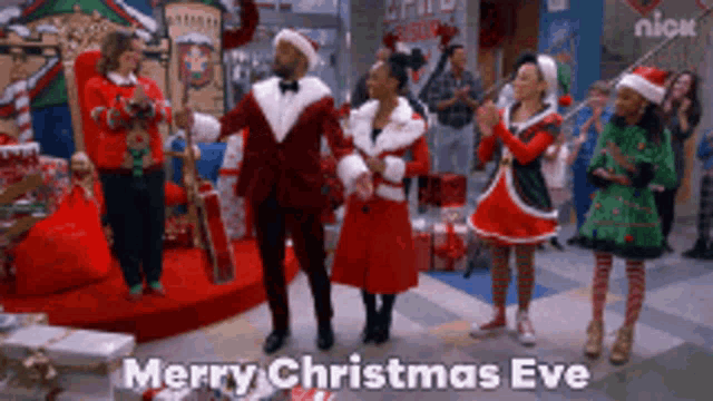 a group of people are dancing in a room with the words merry christmas eve above them