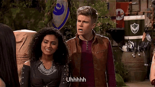 a man and a woman are standing next to each other and the man is saying uhhhh