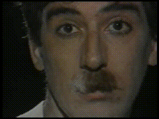 a close up of a man 's face with a mustache on it