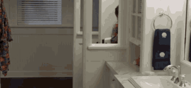 a bathroom with a sink a mirror and a window
