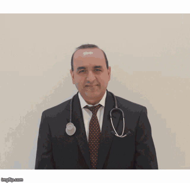 a man with a stethoscope around his neck is wearing a suit and tie