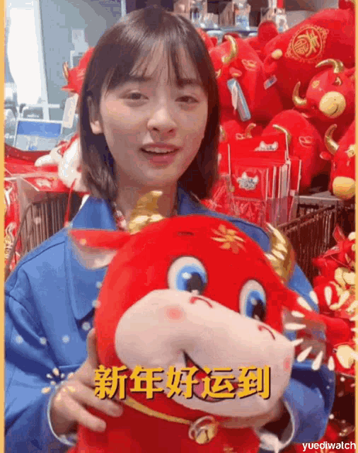 a girl is holding a stuffed animal in front of a bunch of stuffed animals