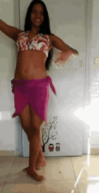 a woman in a pink skirt is standing in front of a door