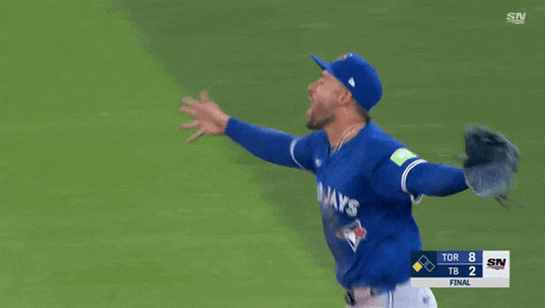 a baseball player wearing a blue jays jersey is standing on the field .
