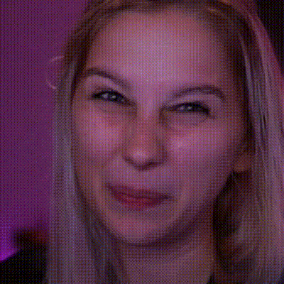 a close up of a woman 's face with a pink background