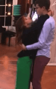 a man and woman are dancing together on a dance floor .