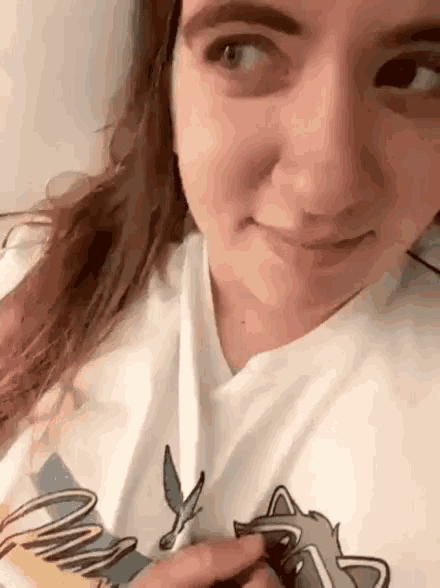 a woman wearing a white shirt with a raccoon on it