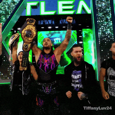 a group of wrestlers are standing in front of a screen that says flea