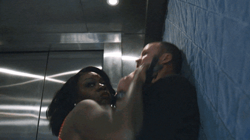 a man and a woman are standing next to each other in a room