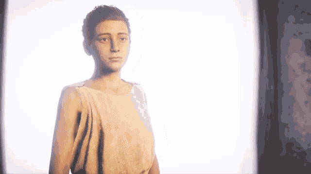 a woman is standing in front of a white wall .