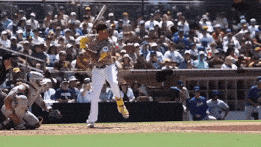 a baseball player wearing a san diego uniform swings his bat