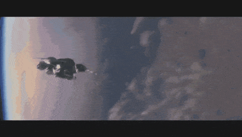 a space ship is flying through the air with a cloudy sky in the background