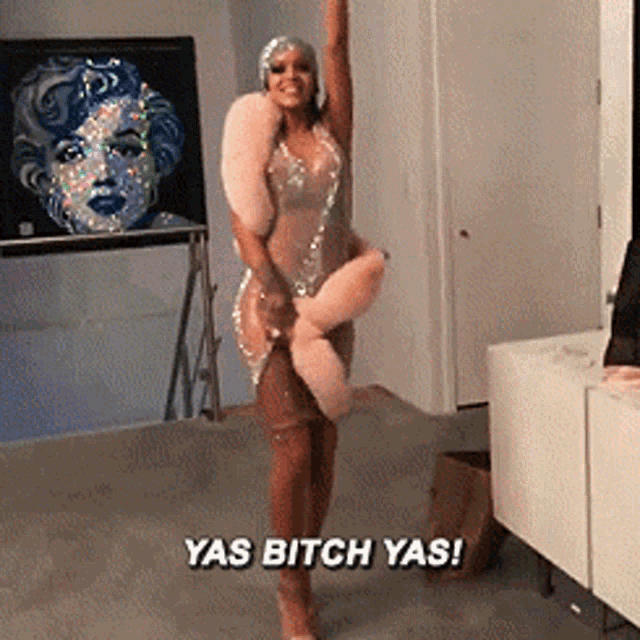 a woman in a dress is holding a stuffed animal and says yas bitch yas !