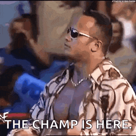 a man wearing sunglasses and a shirt is sitting in a boxing ring .