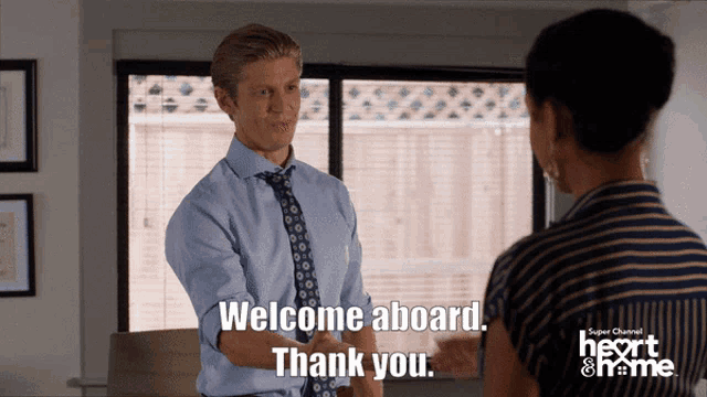 a man shakes hands with a woman who says welcome aboard