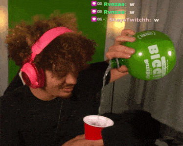 a man wearing pink headphones pouring liquid into a cup