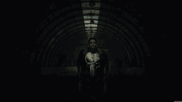 a man in a punisher costume is holding two guns