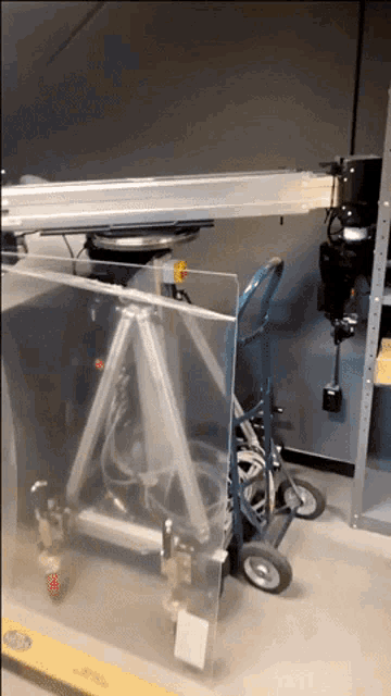 a cart with a clear item on it that says ' acrylic ' on the side