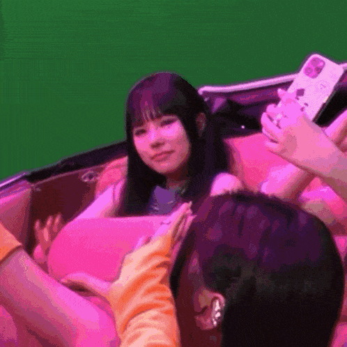 a woman taking a picture of another woman with her phone
