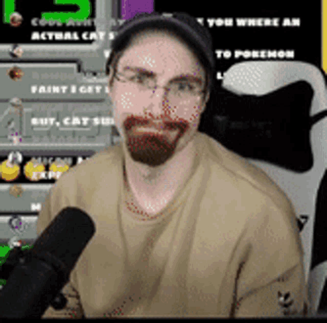 a man with glasses and a beard is holding a microphone