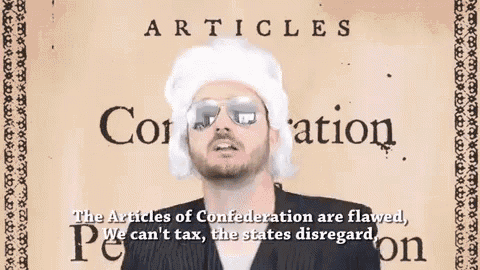 a man wearing a wig and sunglasses is standing in front of a sign that says articles