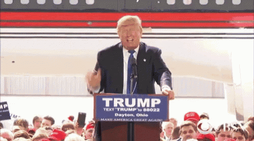 donald trump is giving a speech at a podium with a sign that says trump