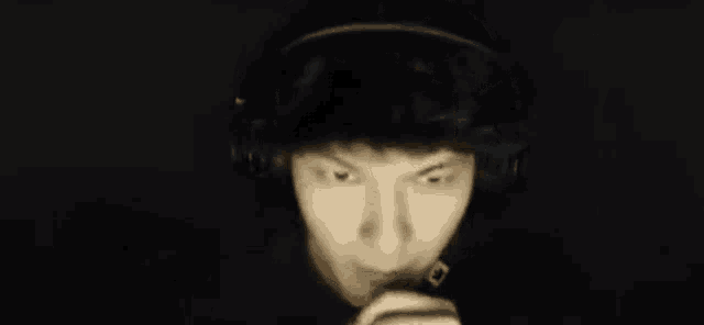 a man wearing headphones is making a scary face