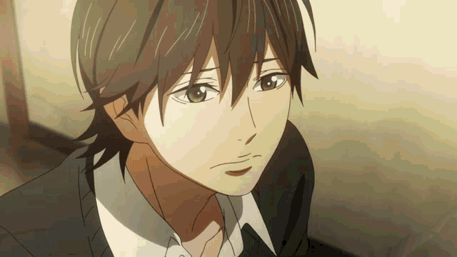 a close up of a person 's face with brown hair and a white shirt