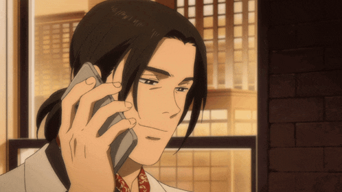 a man with long hair is talking on a phone