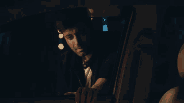 a man in a car is looking out the window