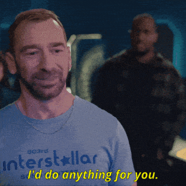 a man wearing a blue shirt that says interstellar says " i 'd do anything for you "