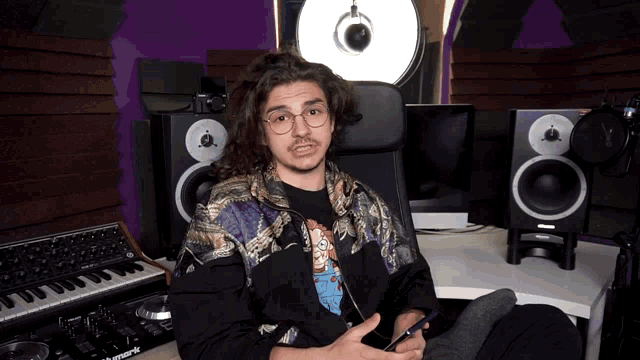 a man is sitting in front of a mixer that says ' pioneer ' on it