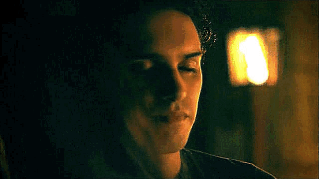 a close up of a man 's face with his eyes closed .