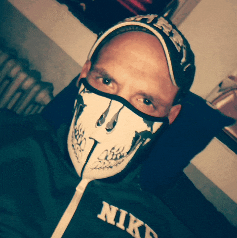 a man wearing a skull mask and a nike jacket