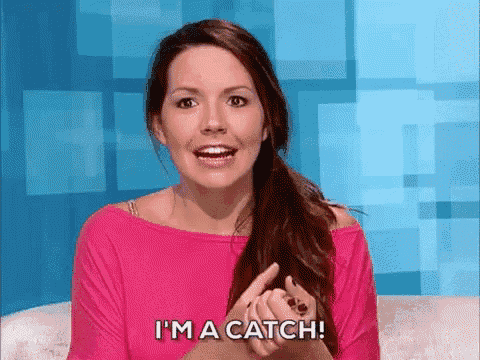 a woman in a pink shirt is saying `` i 'm a catch '' .