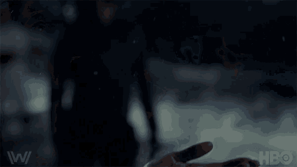 a person 's hand is holding a drop of water in it .