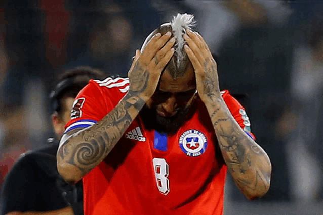 a man wearing a red adidas jersey with the number 8 on the front