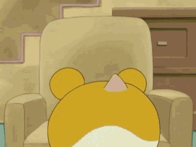 a cartoon character with antlers is sitting in a chair holding a christmas ball .