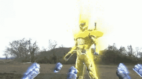 a man in a yellow costume is standing in a field with trees in the background while holding a gun .