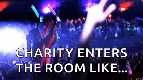 a crowd of people at a charity event with the words charity enters the room like