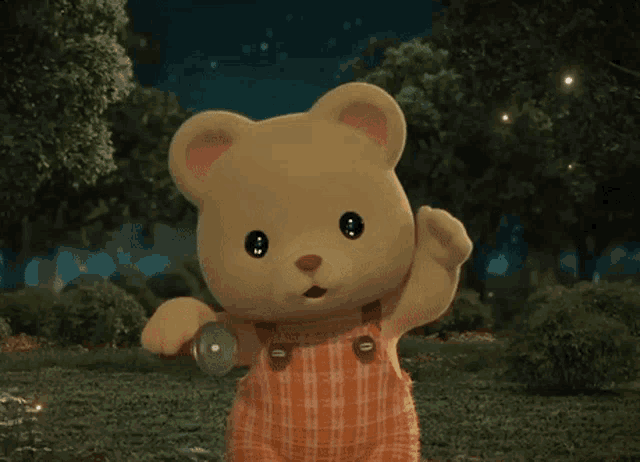 a teddy bear wearing plaid overalls is standing in a forest