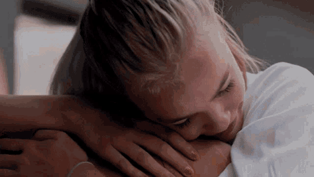a woman is laying down with her head on another woman 's lap
